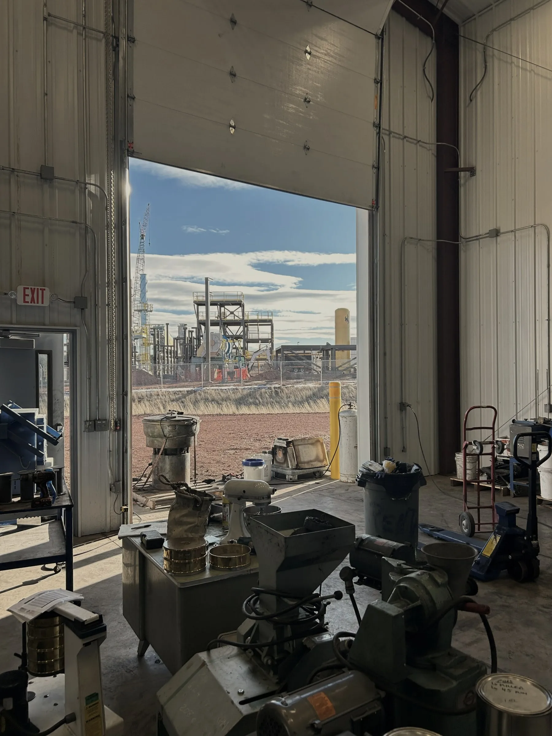Looking out of the pilot bay door toward industrial plant and open Wyoming ground.